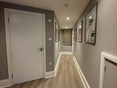 a hallway with a white door in a house at Strand Suites in Douglas