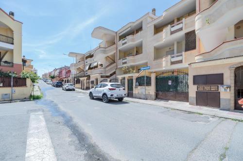a car parked on the side of a street with buildings at Sestu Lovely Apt W/ Balcony near Spiaggia Poetto! in Sestu