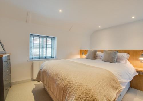a bedroom with a large bed and a window at 3 Port in Holt