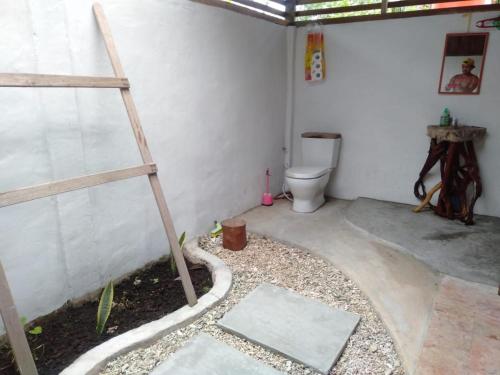 a bathroom with a ladder and a toilet in a room at Mentawai Balcony in Masokut