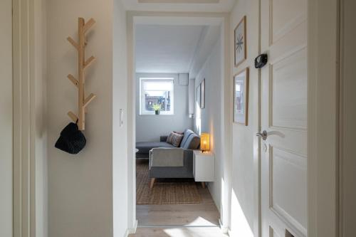 a hallway leading to a living room with a couch at Newly renovated 1-Bed Apartment in Aalborg in Aalborg