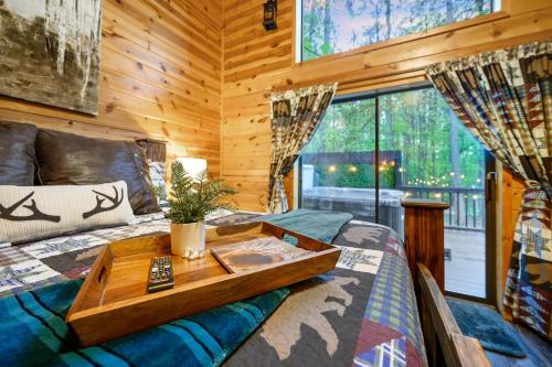 ein Schlafzimmer mit einem Bett und einem Tablett darauf in der Unterkunft Hickory Bear - Cabin surrounded by pines, Sleeps 10, Hot Tub, Fire Pit, Arcade, Foosball Table & Deck Slide in Broken Bow