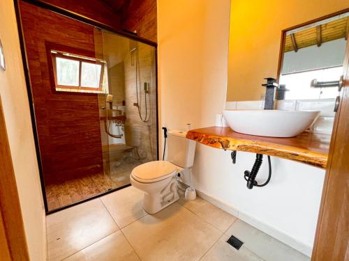 uma casa de banho com um lavatório, um WC e um chuveiro em Linda casa em condomínio fechado com vista para Ilha das Cabras em Ilhabela