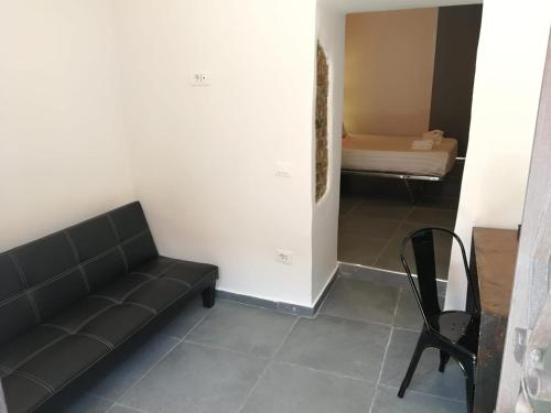 a living room with a couch and a bed and a chair at Hotel Assisivm Antica Dimora AD in Assisi