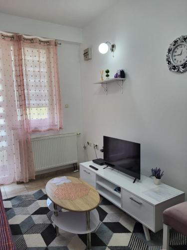 a living room with a tv and a table at Lavander in Banja Luka