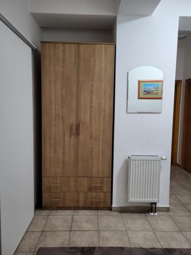 a room with a wooden cabinet and a radiator at Lavander in Banja Luka