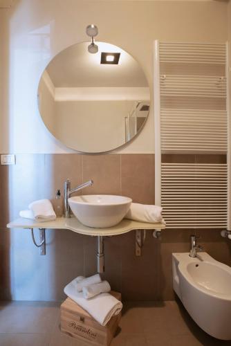 a bathroom with a sink and a mirror at Coltivare AgriRelais in La Morra