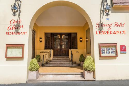 a entrance to a building with a door and stairs at L'Hotel De L'Esperance in Lisieux