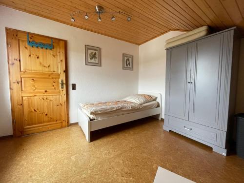 a bedroom with a bed and a wooden ceiling at Ferienwohnung zum Nürburgring in Münk