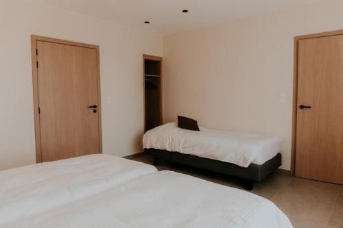 a bedroom with two beds and a laptop on top of it at Luxe Vakantiewoning De Veldhoek in Wingene