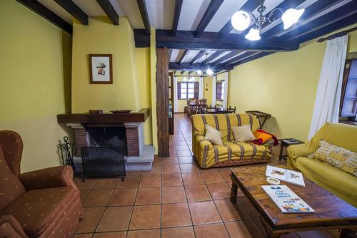 a living room with couches and a fireplace at PENSION ONIS in Benia de Onís