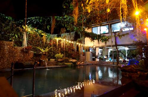 a swimming pool with christmas lights in a building at Lavs Valley in Dapdap
