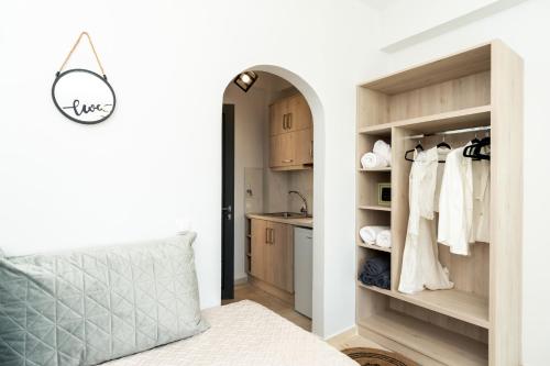 a bedroom with a bed and a closet with a sink at Villa Milano in Laganas