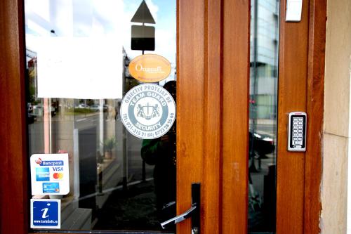 a door with a sign on the door of a building at Occidental Wise Transit in Bucharest