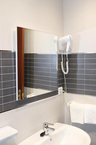 a bathroom with a sink and a mirror at Hotel Fin De Semana in Gandía