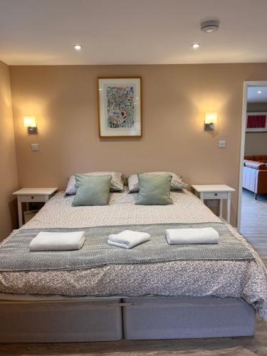 a bedroom with a large bed with two pillows on it at The Piggery in Chichester