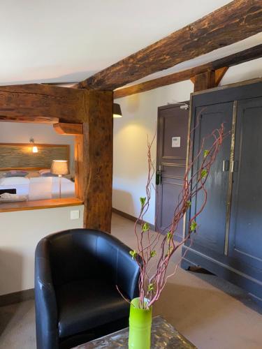 a room with a table and a chair and a bed at Logis Hôtel Château De Palaja in Carcassonne
