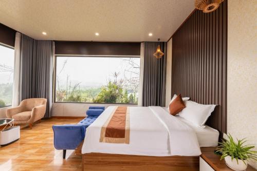 a bedroom with a large bed and a large window at TAM COC SUNSHINE HOTEL in Ninh Binh