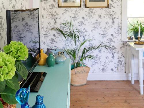 a room with a table with vases and plants at 6 person holiday home in ULLARED in Ullared