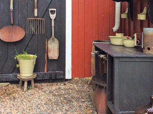 a kitchen with a stove and utensils on a wall at 6 person holiday home in ULLARED in Ullared