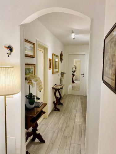 a hallway with a table and a lamp at Casa Luba in Lucca