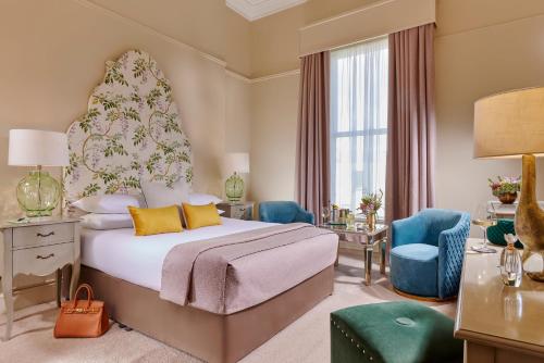 a hotel room with a bed and two chairs at Ariel House in Dublin