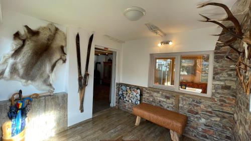 a room with a stone wall with skis on the wall at Ferienwohnung Brandmaier in Unken