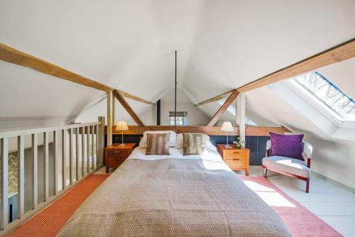 a bedroom with a large bed in a attic at Whitechurch Stables 