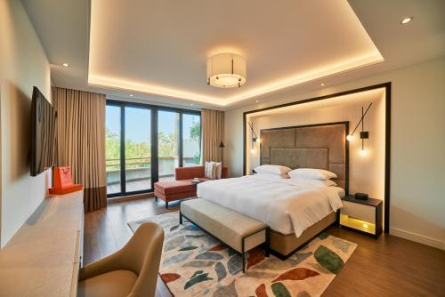a bedroom with a large bed and a large window at Grand Hyatt Residence in Dubai