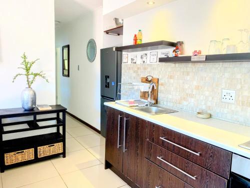 a kitchen with a sink and a counter top at Regent Casa's - Cape Towns Blouberg Area - Where 20 people can stay in Cape Town