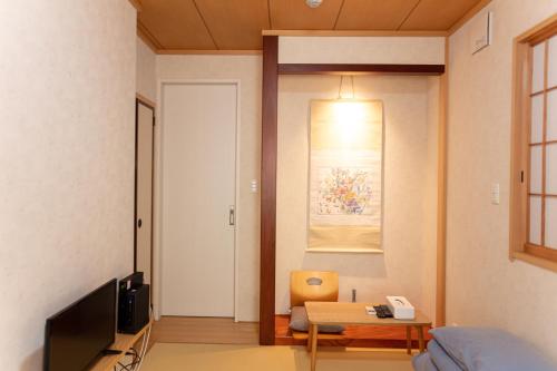 a living room with a tv and a couch and a table at 和縁WAEN SKYTREE in Tokyo