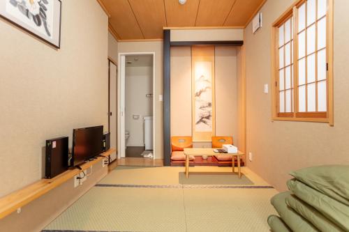 a living room with a tv and a couch at 和縁WAEN SKYTREE in Tokyo