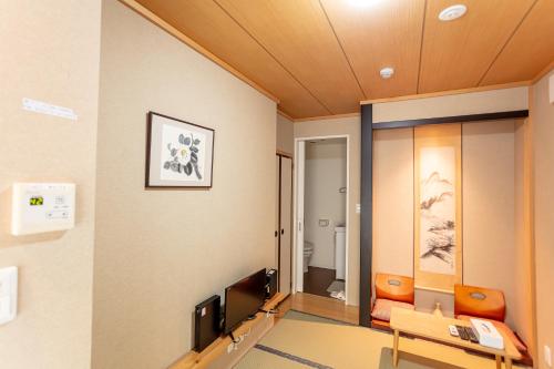 a room with a waiting room with a tv and a desk at 和縁WAEN SKYTREE in Tokyo
