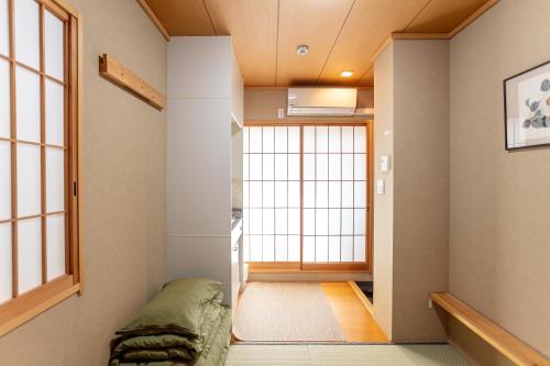a room with a bed and a large window at 和縁WAEN SKYTREE in Tokyo