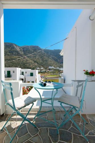 a table and two chairs sitting on a balcony at Iliofegaro in Kamarai