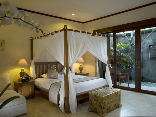 a bedroom with a large bed with a canopy at The Citta Luxury Residence in Seminyak