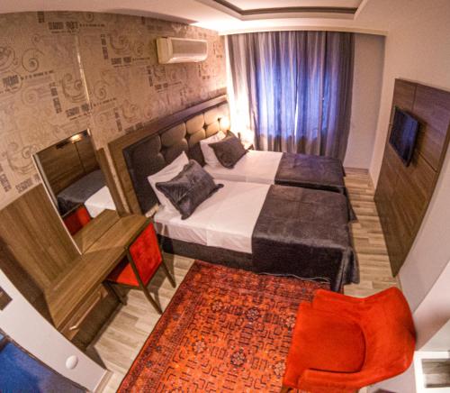 a hotel room with a bed and a table and a chair at New Akçaabat Hotel in Akcaabat