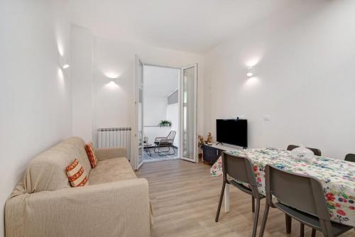 a living room with a table and a couch at Moneglia Monte in Moneglia