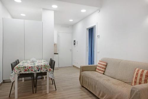 a living room with a table and a couch at Moneglia Monte in Moneglia