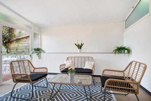 a living room with three chairs and a table at Moneglia Monte in Moneglia
