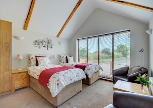 a bedroom with two beds and a window at Badger Set in Cantley
