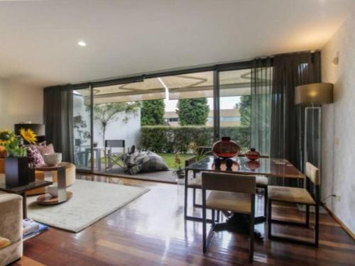 a living room with a table and a large window at Quinta da Barca House - Nada melhor que juntar Luxo a Lazer com mar e rio! in Esposende
