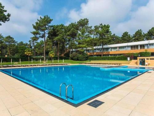 a large swimming pool with blue water at Quinta da Barca House - Nada melhor que juntar Luxo a Lazer com mar e rio! in Esposende
