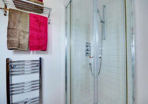 a bathroom with a shower and a red towel at Badger Set in Cantley
