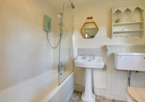 a bathroom with a sink and a shower at Baytree Cottage in Melton Constable