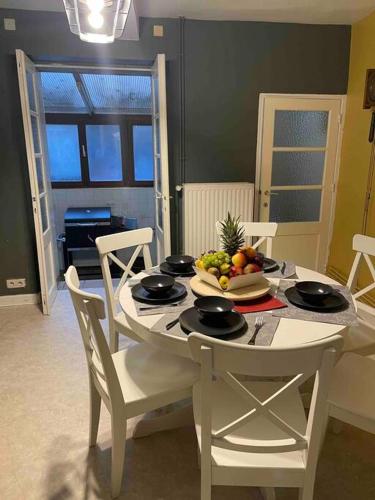 a dining room table with a bowl of fruit on it at B&B ArdennesT in Bouillon