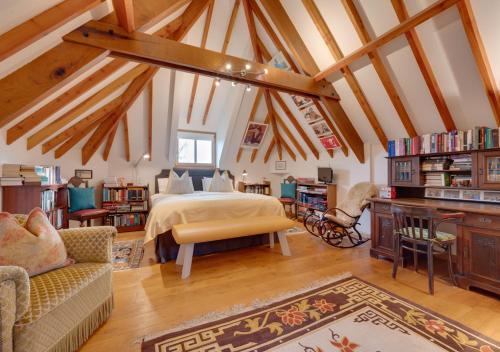 a bedroom with a bed in a room with wooden beams at Bluddles Dairy in Somerton