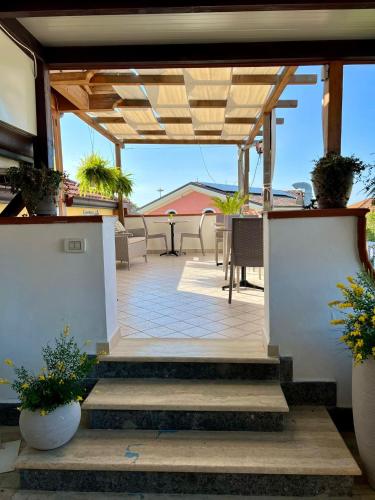 an outdoor patio with a wooden pergola and plants at B&B A Casa di Vittoria - Guest House in Castellabate