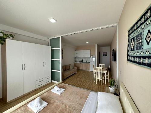 a small room with a bed and a kitchen at Despacito Port Side in Vlorë