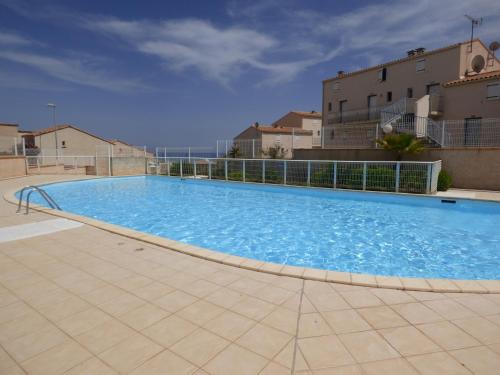 une grande piscine bleue dans un immeuble dans l'établissement Pavillon T2 Mezzanine, piscine, Mer Indigo, St Pierre la Mer, à Saint Pierre La Mer